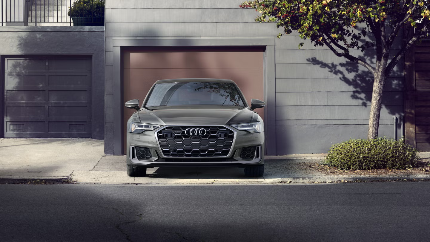 Audi SQ8 on a coastal road at dusk